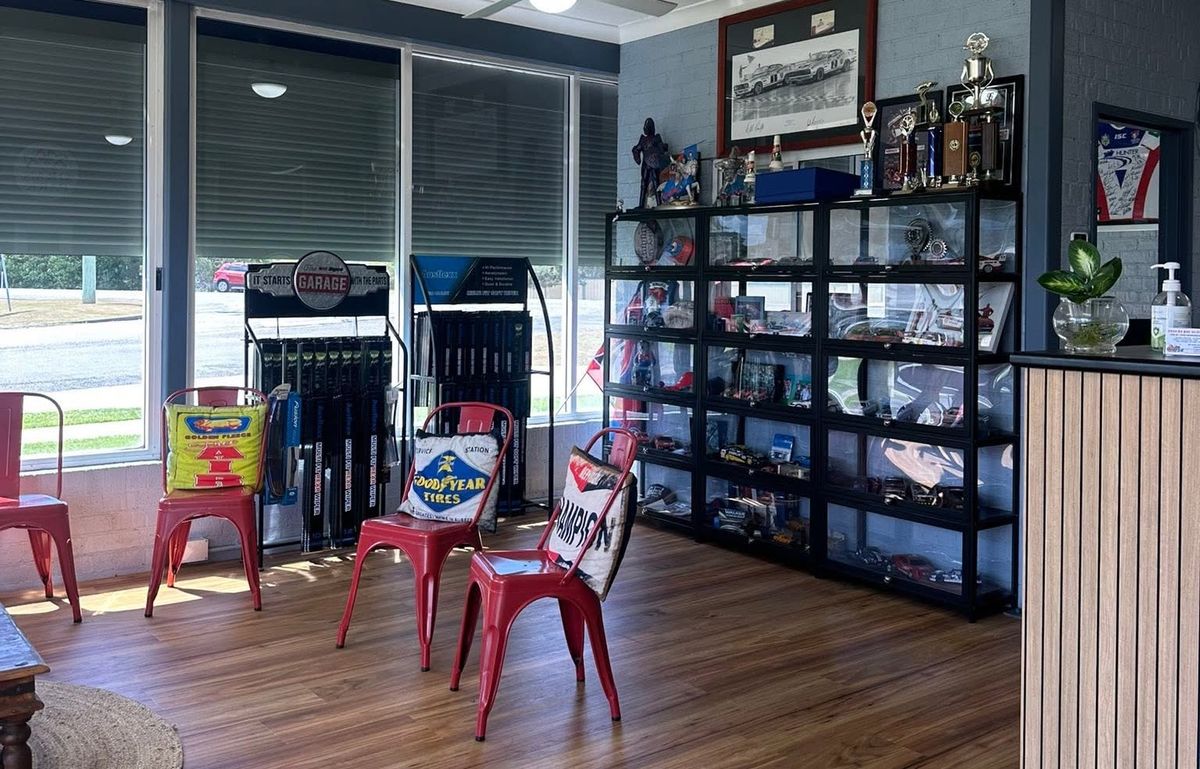 Customer waiting area at Tanilba Bay Automotive with trophies and model car display